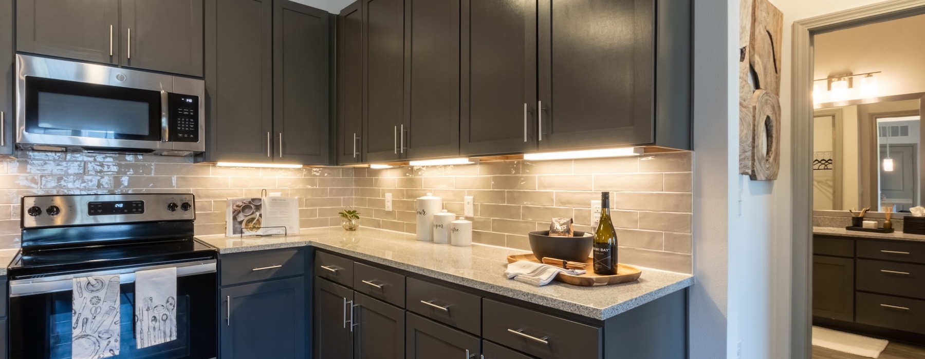 a kitchen with dark cabinets