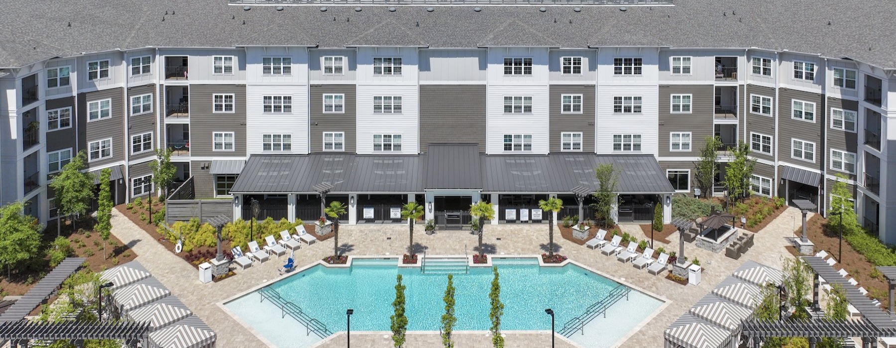 a large building with a pool in front of it