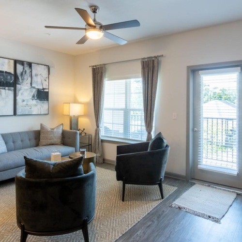 a living room with a couch and chairs
