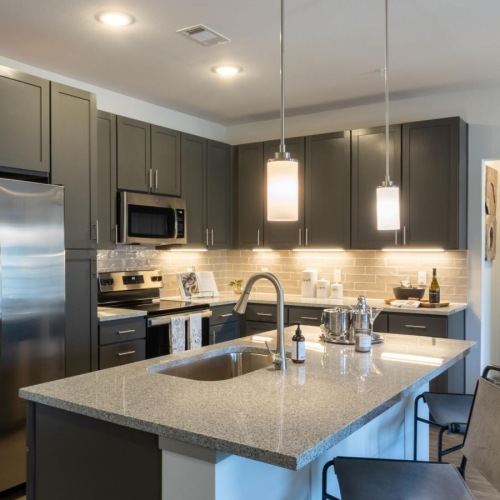 a kitchen with a stainless steel refrigerator